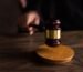 A gavel striking a sound block, symbolizing justice and legal authority in a courtroom setting.
